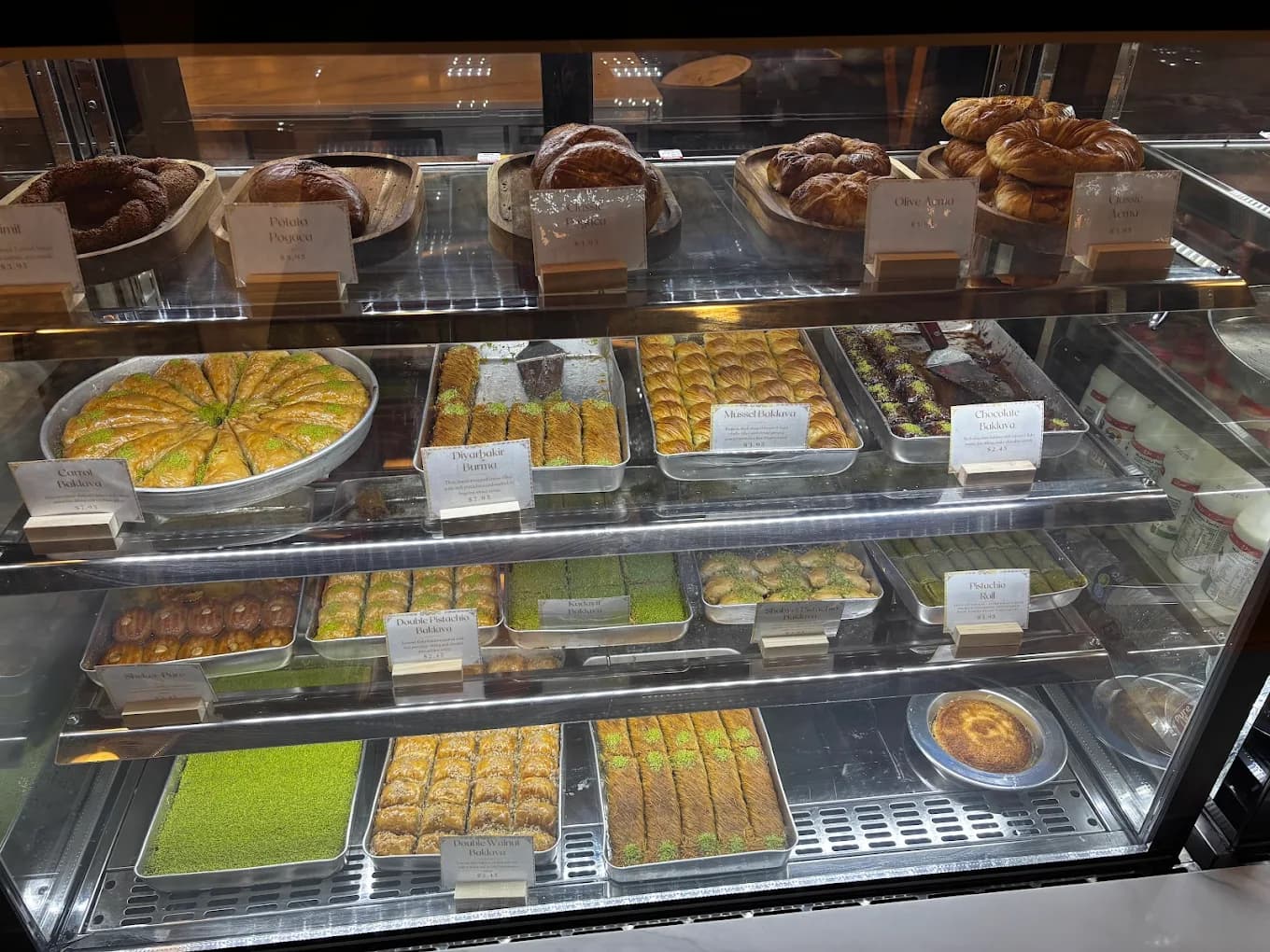 Bakery display case with baklava and desserts