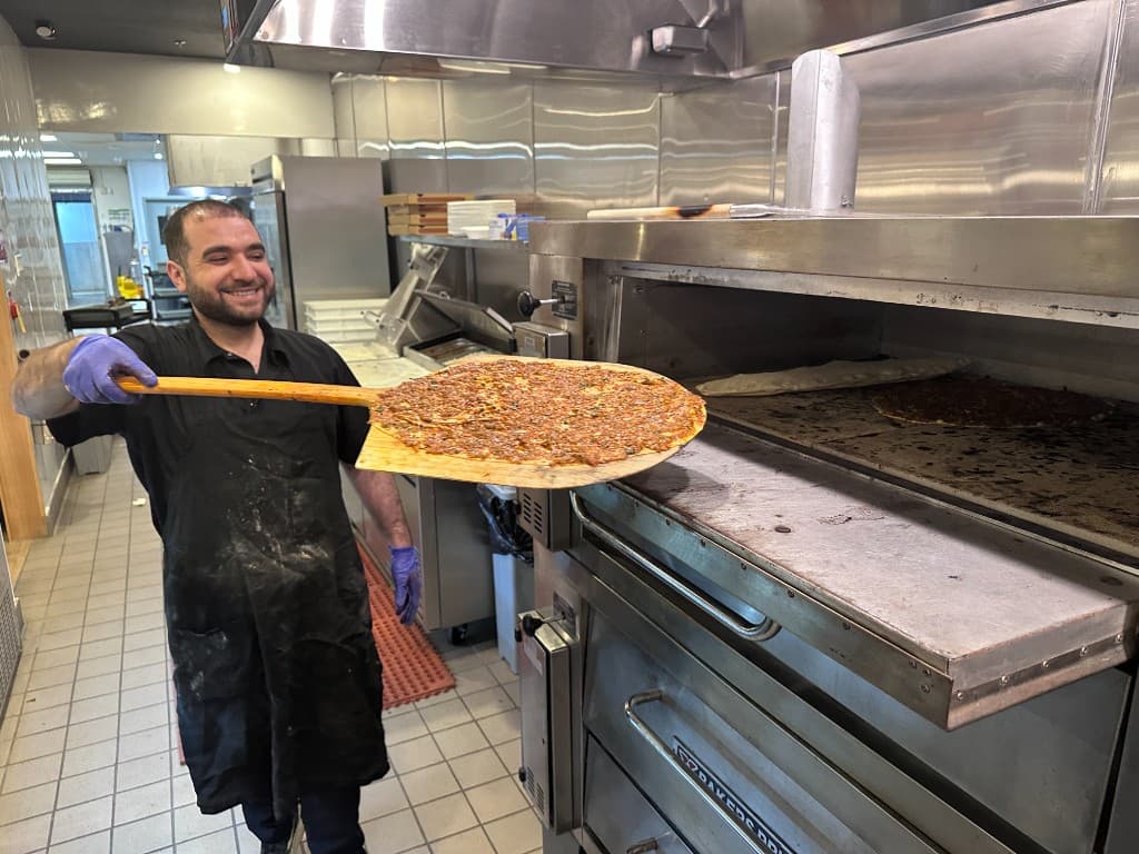 Chef preparing Lahmacun in the stone oven at Istanbul Mediterranean 2